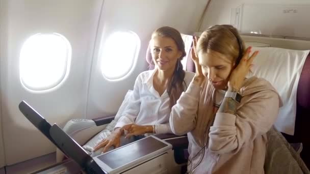 girls listening music on airplane